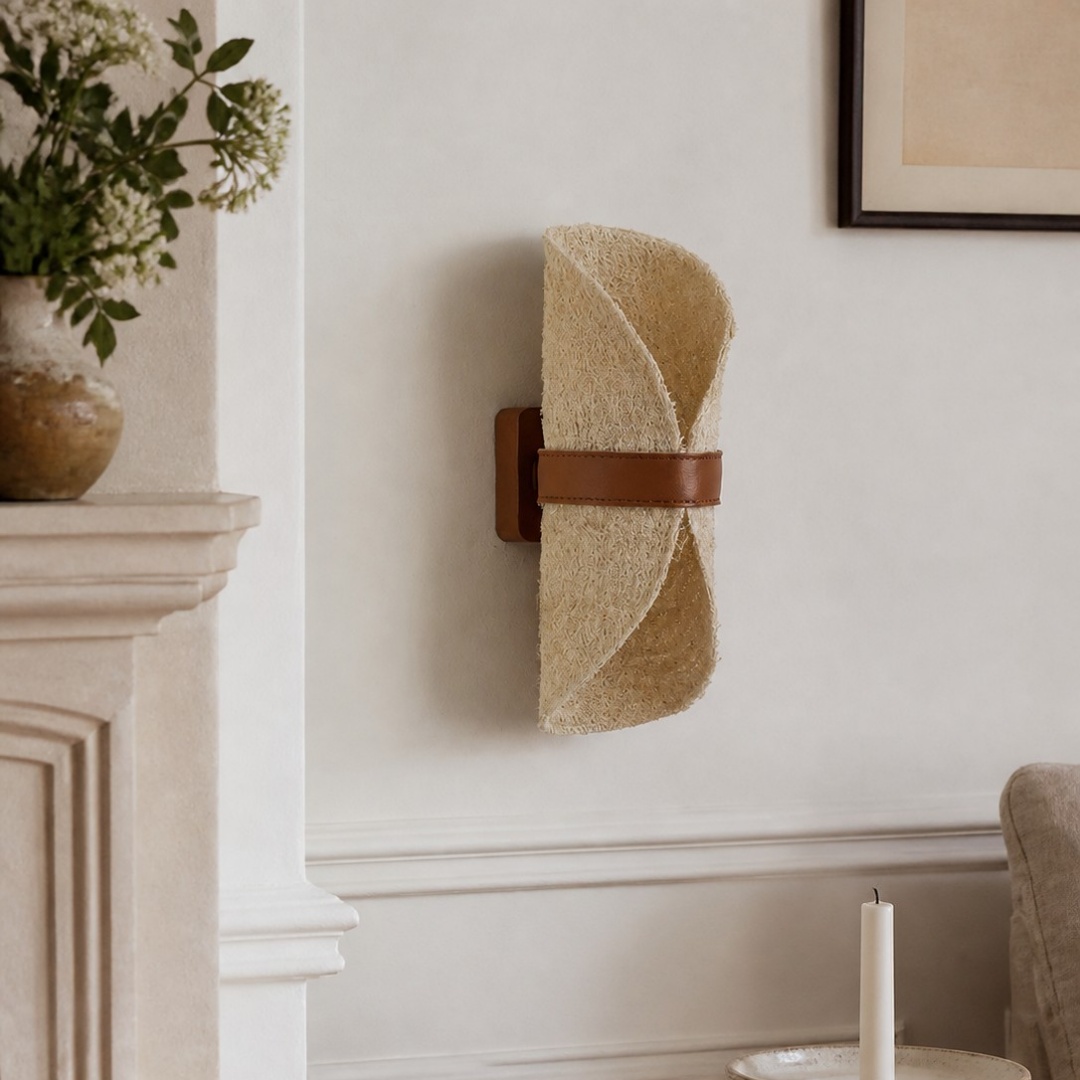 Natural loofah and leather wall sconce in a refined neutral interior